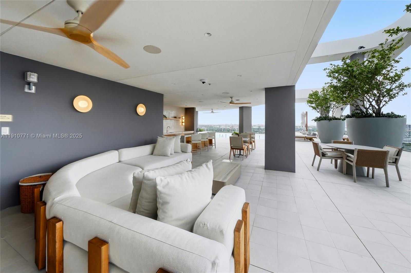 2678 Tigertail Avenue, Unit 1110 Miami, FL 33133 - Photo 46 of 77 a living room with furniture and a potted plant