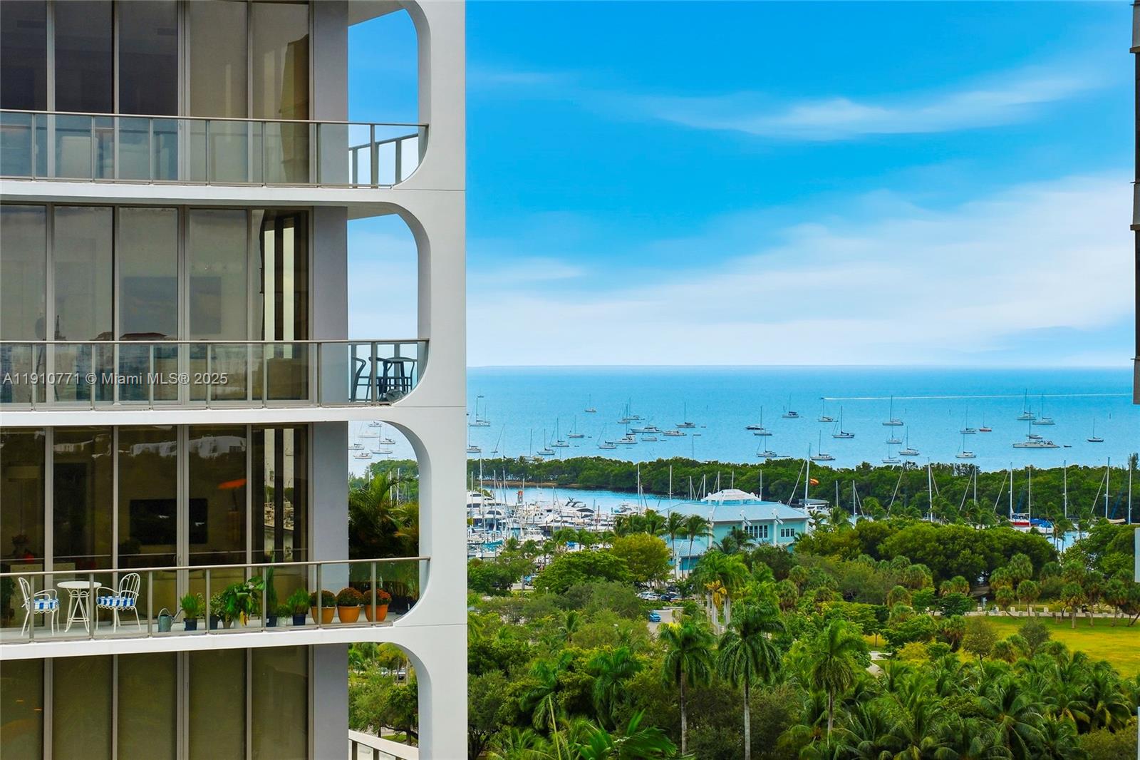 2678 Tigertail Avenue, Unit 1110 Miami, FL 33133 - Photo 5 of 77 a view of a large building with a big yard and large trees