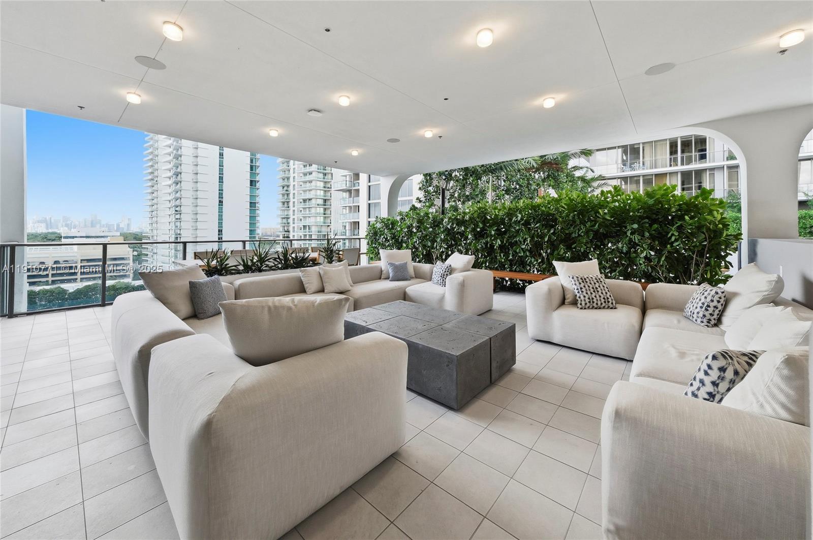 2678 Tigertail Avenue, Unit 1110 Miami, FL 33133 - Photo 54 of 77 a living room with furniture kitchen view and a large window