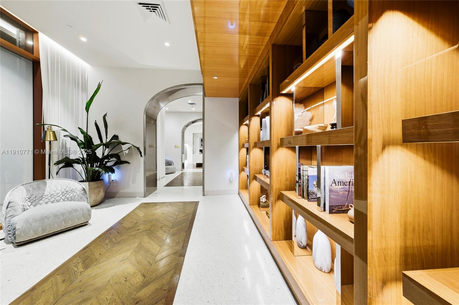 2678 Tigertail Avenue, Unit 1110 Miami, FL 33133 - Photo 61 of 77 a hallway with furniture and a potted plant