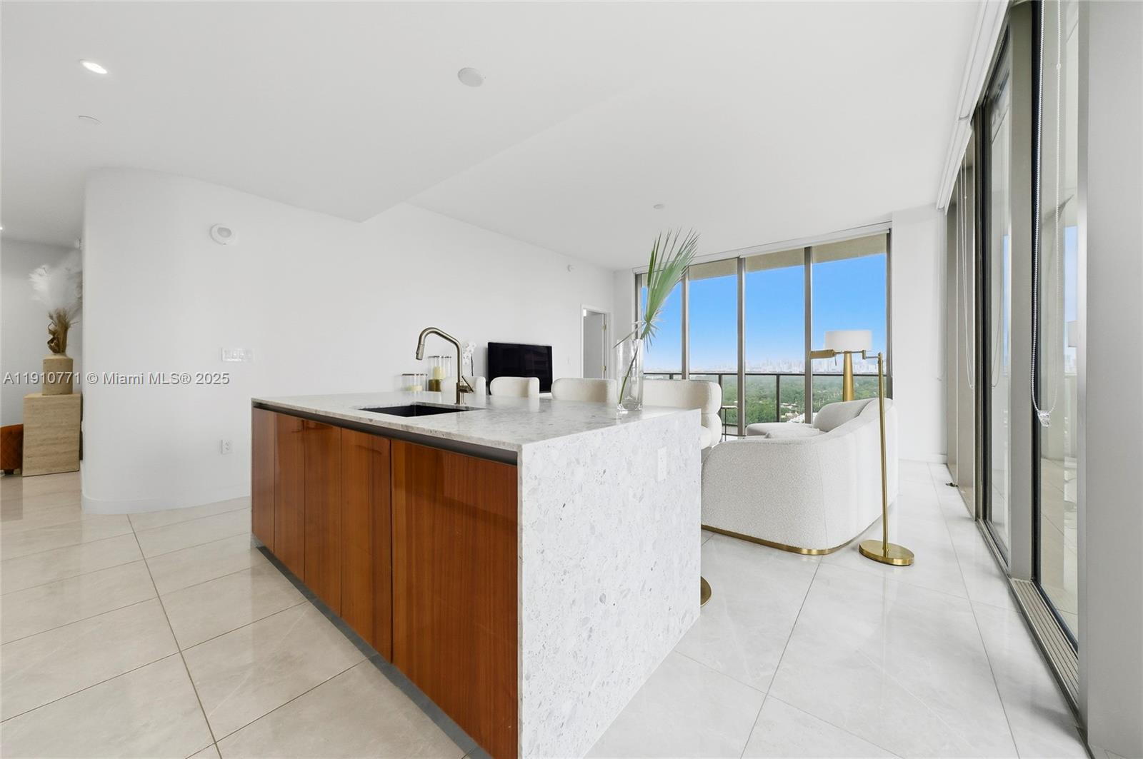 2678 Tigertail Avenue, Unit 1110 Miami, FL 33133 - Photo 8 of 77 a kitchen with kitchen island cabinets and refrigerator