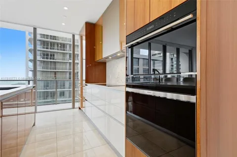 a bedroom with a large bed and a large window