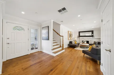 a living room with fireplace furniture and a large window