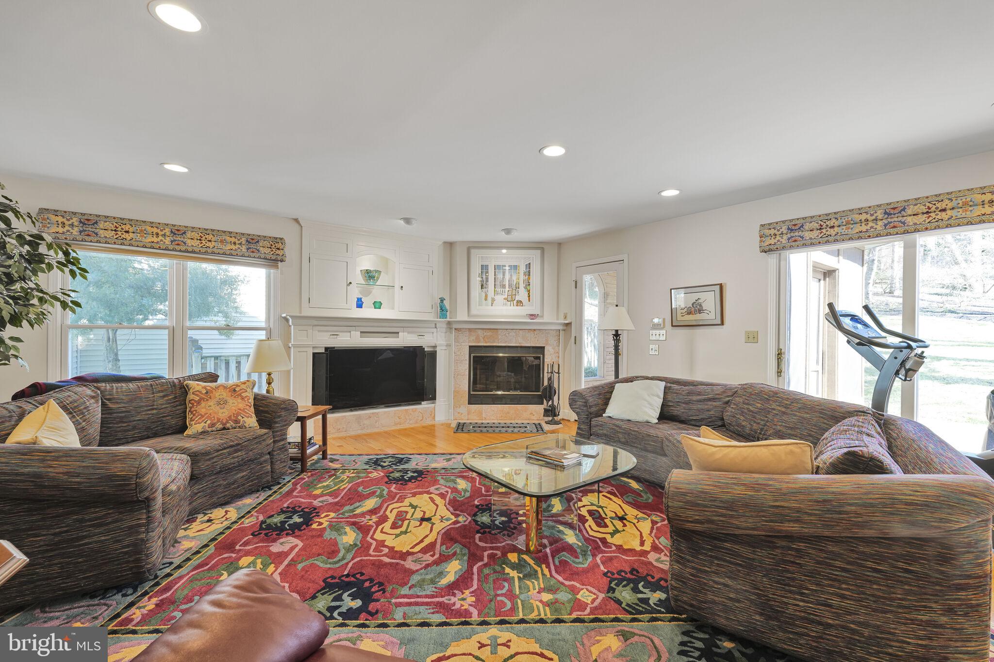 9501 Columbia Boulevard Silver Spring, MD 20910 - Photo 12 of 32 a living room with furniture a flat screen tv and a fireplace