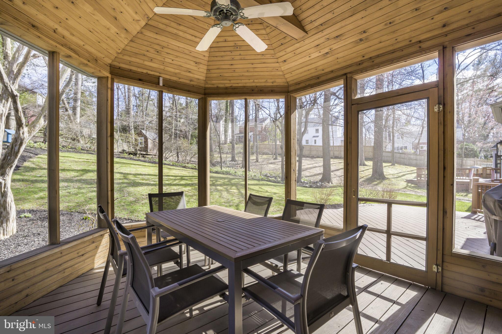 9501 Columbia Boulevard Silver Spring, MD 20910 - Photo 15 of 32 a view of a dining room with furniture large windows and wooden floor