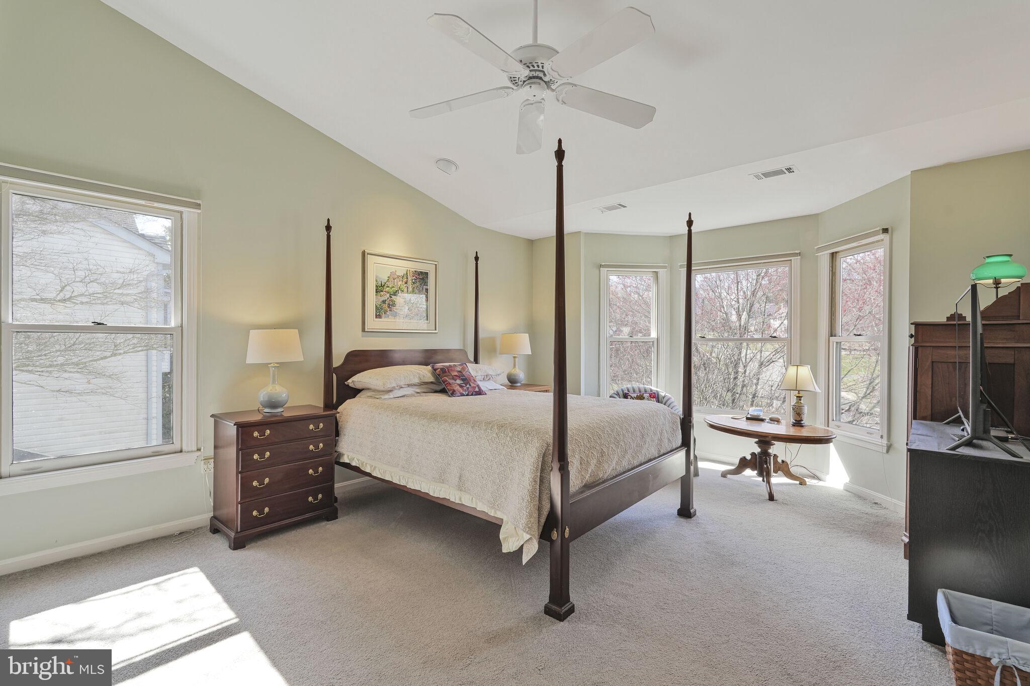 9501 Columbia Boulevard Silver Spring, MD 20910 - Photo 19 of 32 a bedroom with a bed and large windows