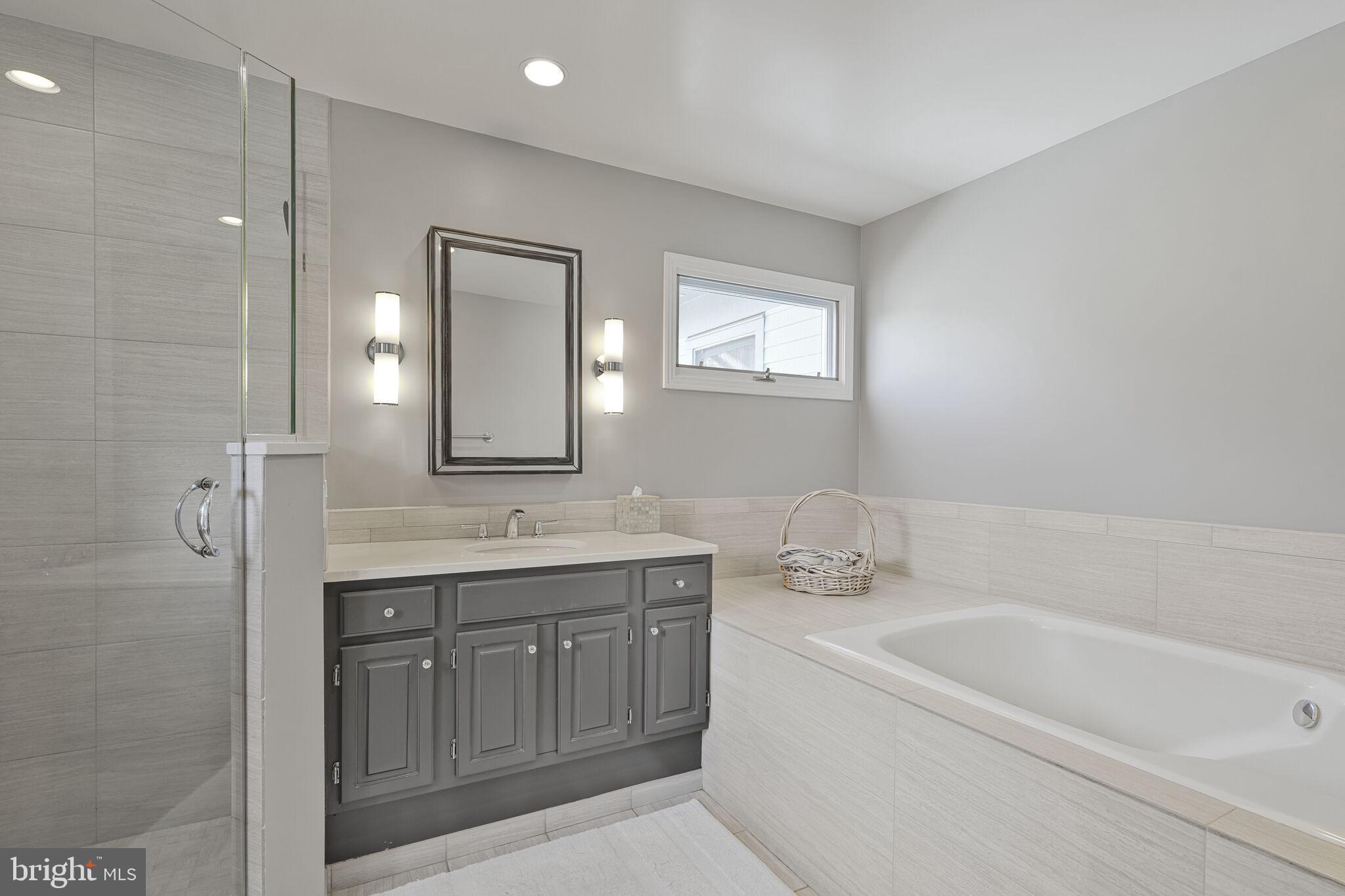 9501 Columbia Boulevard Silver Spring, MD 20910 - Photo 21 of 32 a bathroom with a granite countertop sink a toilet and shower
