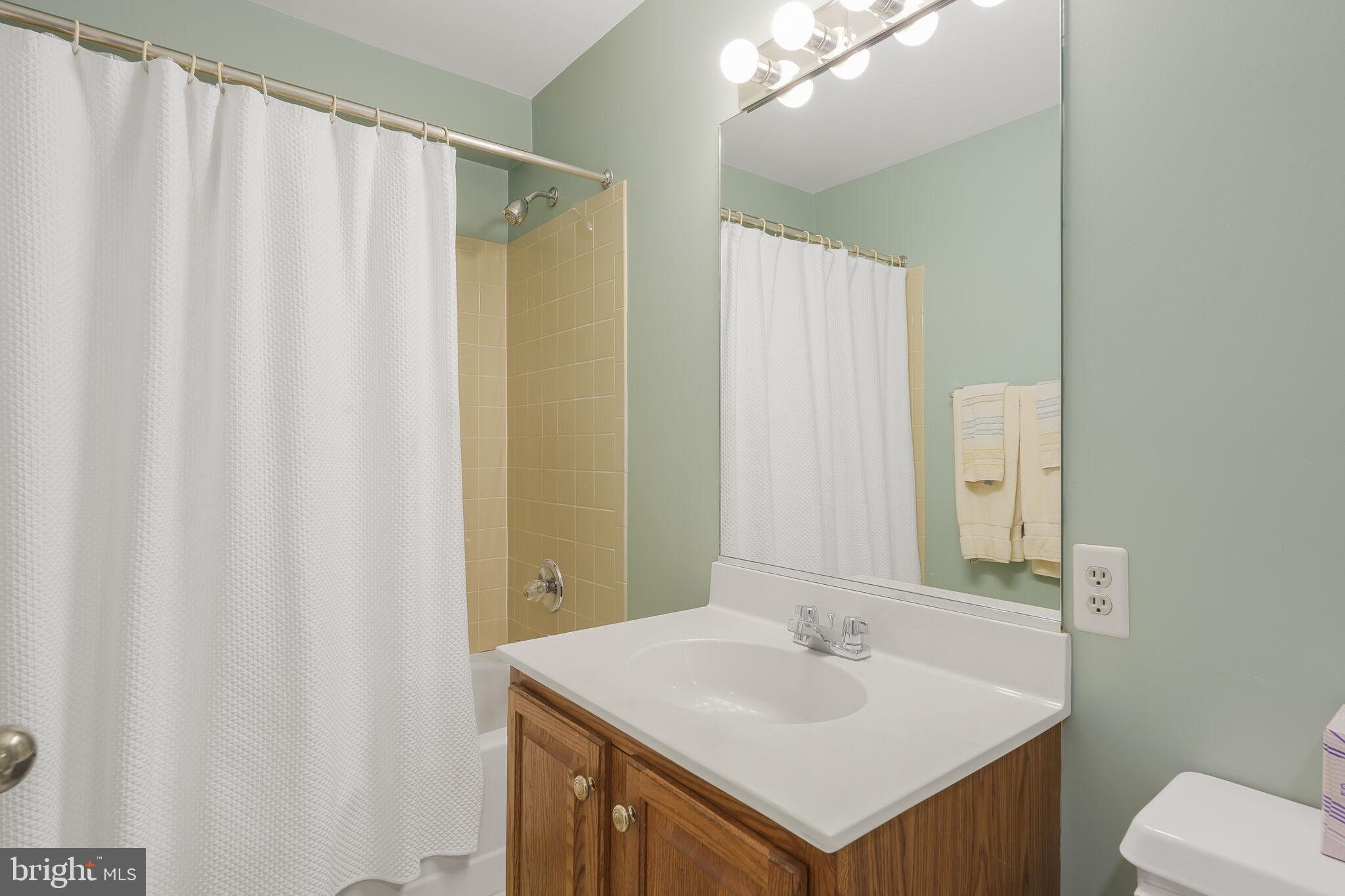 9501 Columbia Boulevard Silver Spring, MD 20910 - Photo 29 of 32 a bathroom with a sink and a mirror