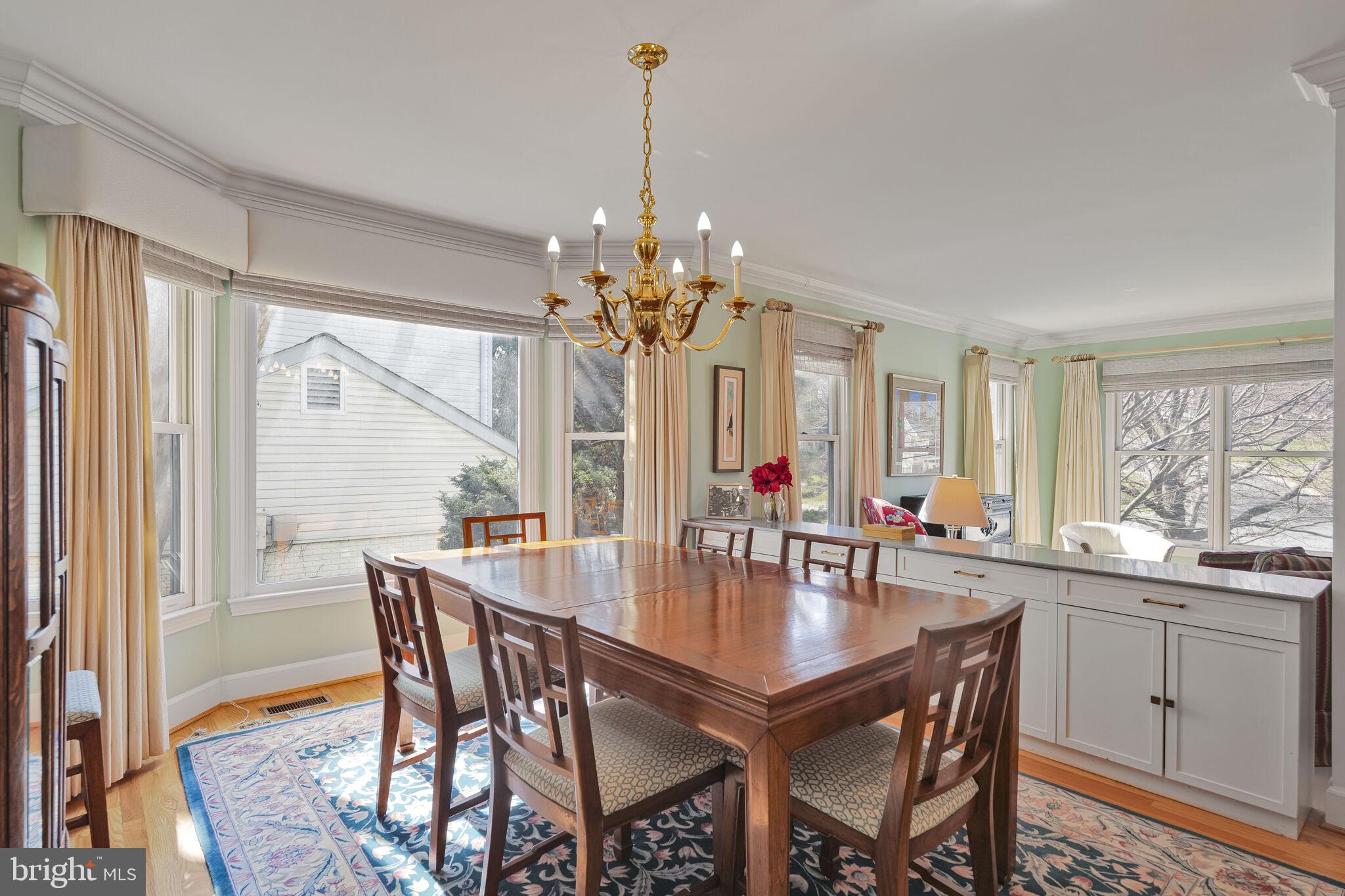 9501 Columbia Boulevard Silver Spring, MD 20910 - Photo 6 of 32 a dining room with furniture a chandelier and wooden floor