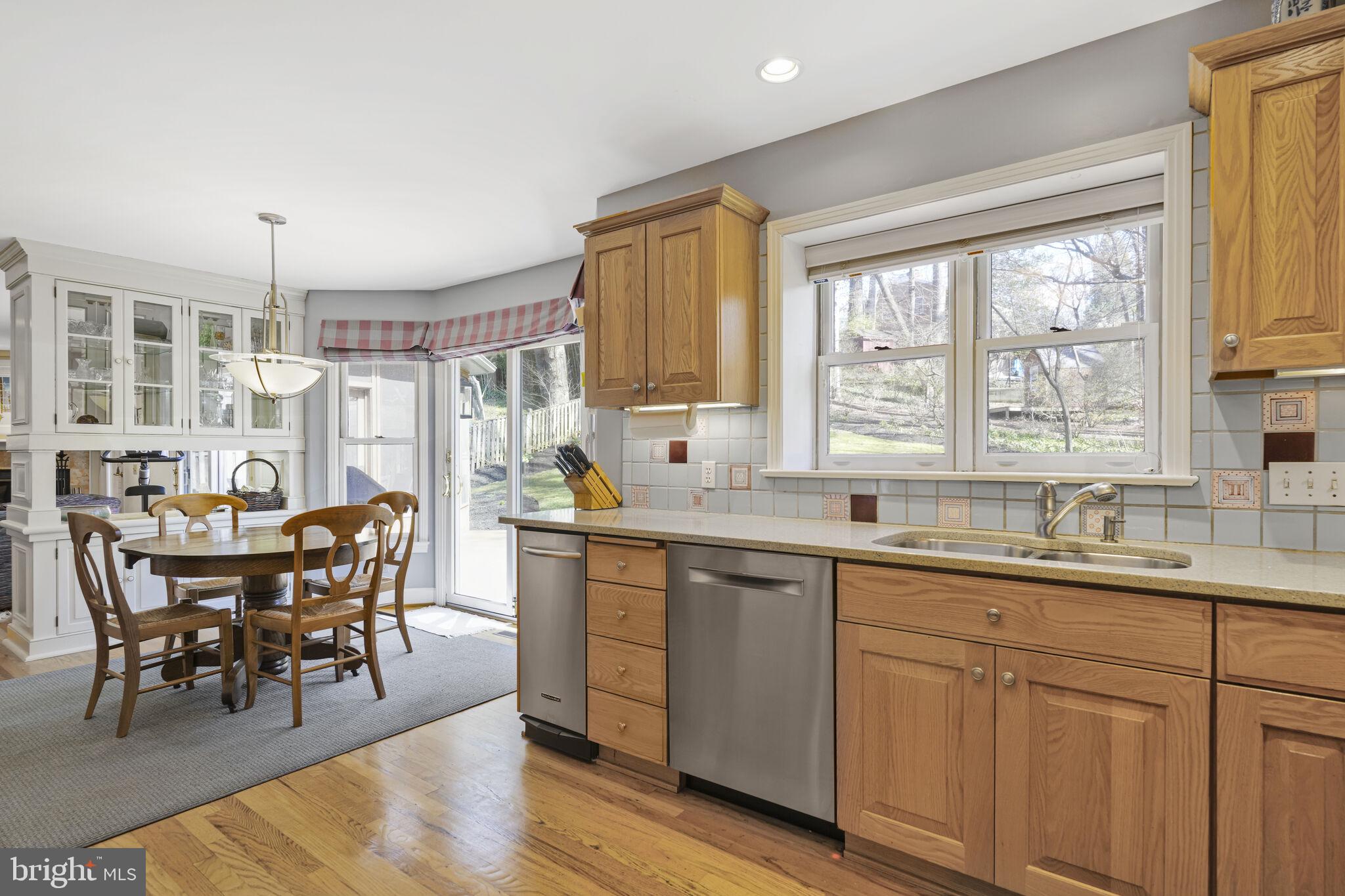 9501 Columbia Boulevard Silver Spring, MD 20910 - Photo 9 of 32 a kitchen with a sink table and chairs