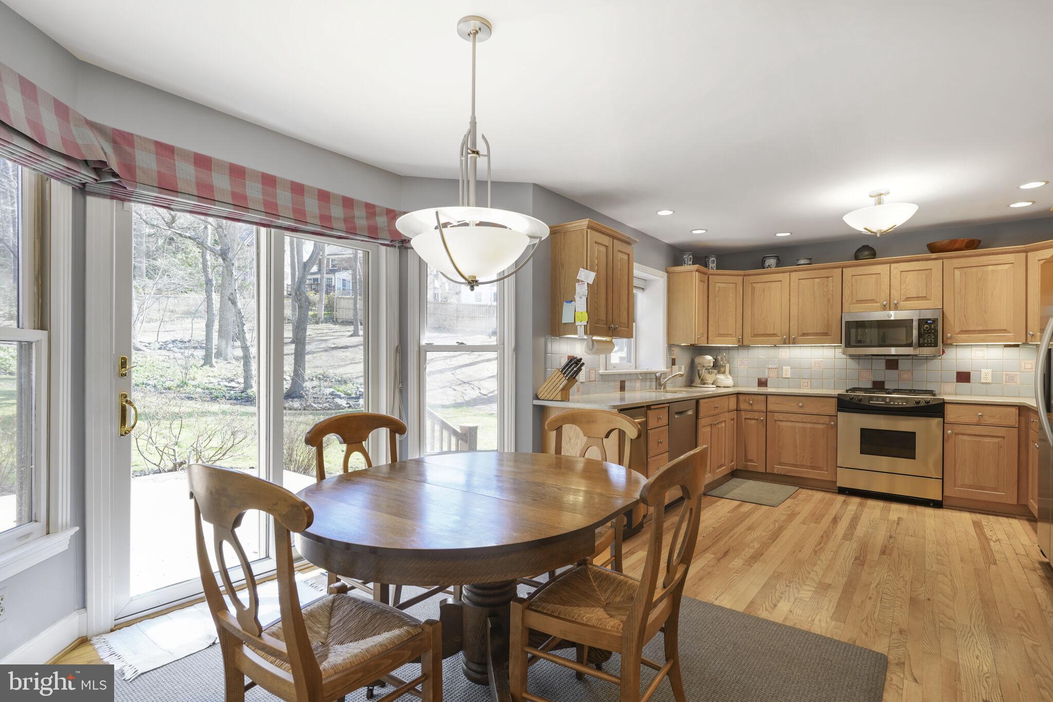 9501 Columbia Boulevard Silver Spring, MD 20910 - Photo 10 of 32 a view of a dining room and livingroom with furniture wooden floor a chandelier