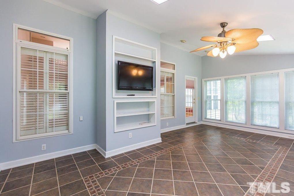 1244 Torchlight Way Raleigh, NC 27603 - Photo 11 of 20 a view of an empty room with a window and a flat screen tv