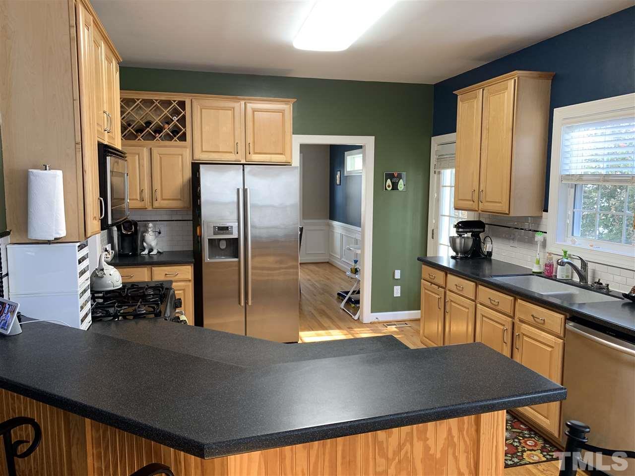1244 Torchlight Way Raleigh, NC 27603 - Photo 13 of 20 a kitchen with stainless steel appliances a sink stove and refrigerator