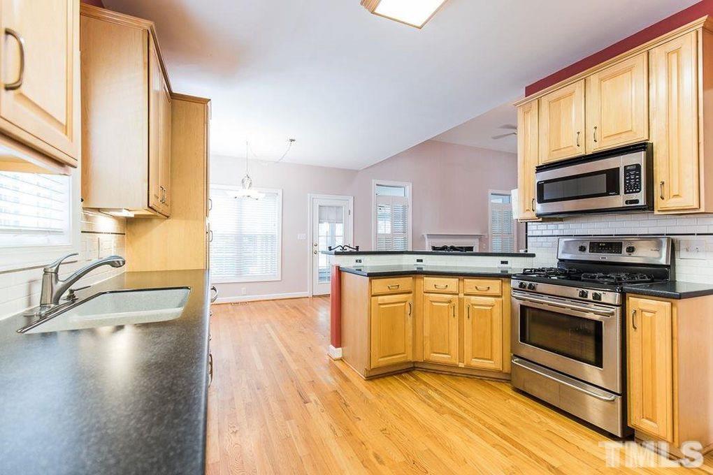 1244 Torchlight Way Raleigh, NC 27603 - Photo 14 of 20 a kitchen with stainless steel appliances granite countertop a stove a sink and a microwave
