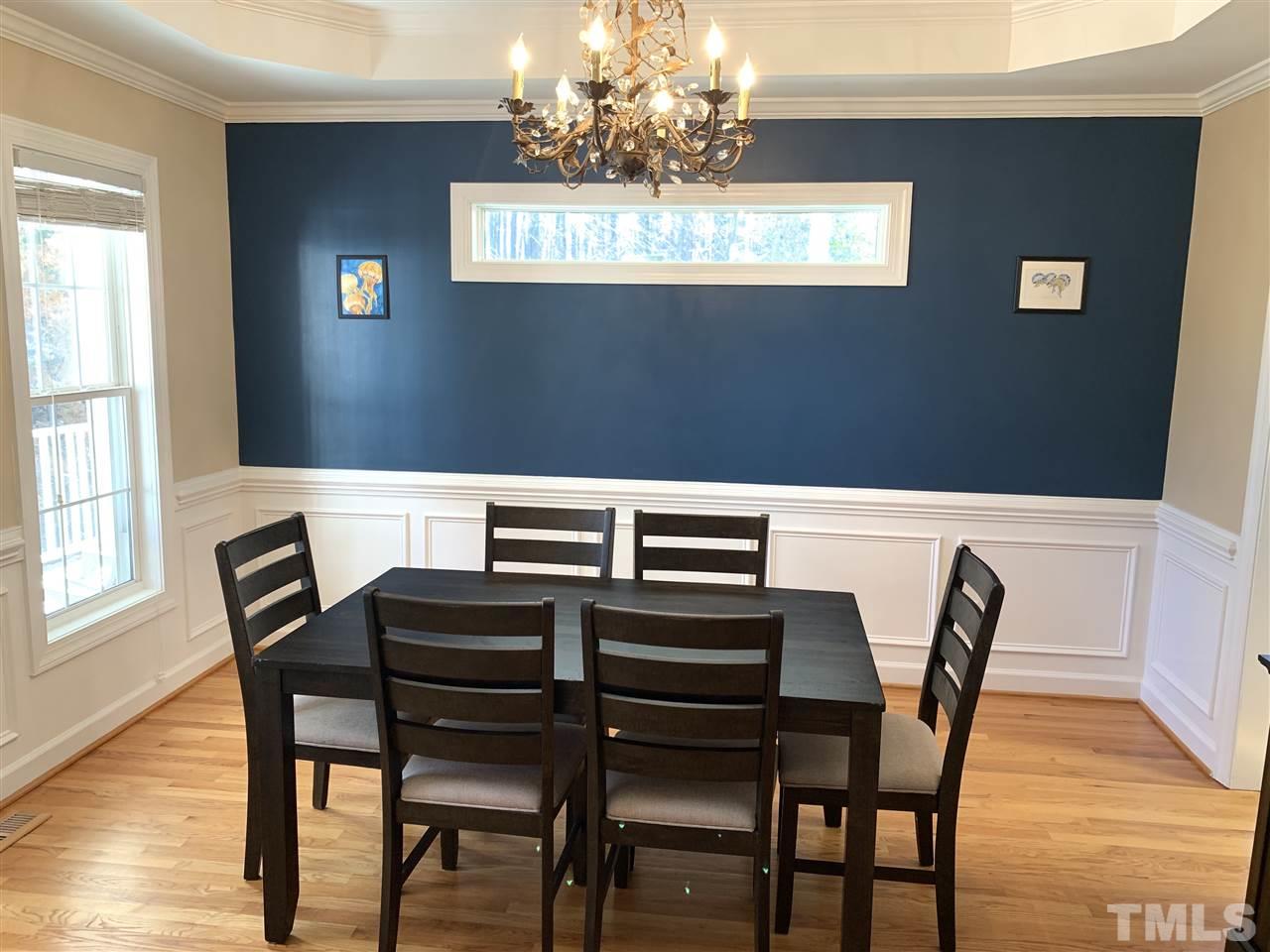 1244 Torchlight Way Raleigh, NC 27603 - Photo 15 of 20 a view of a dining room with furniture and wooden floor