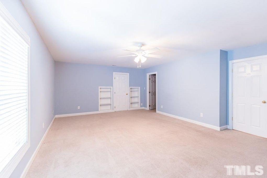 1244 Torchlight Way Raleigh, NC 27603 - Photo 17 of 20 an empty room with a window and a kitchen