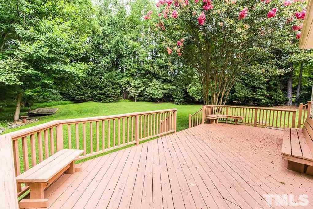 1244 Torchlight Way Raleigh, NC 27603 - Photo 19 of 20 a balcony with wooden floor and trees in the background