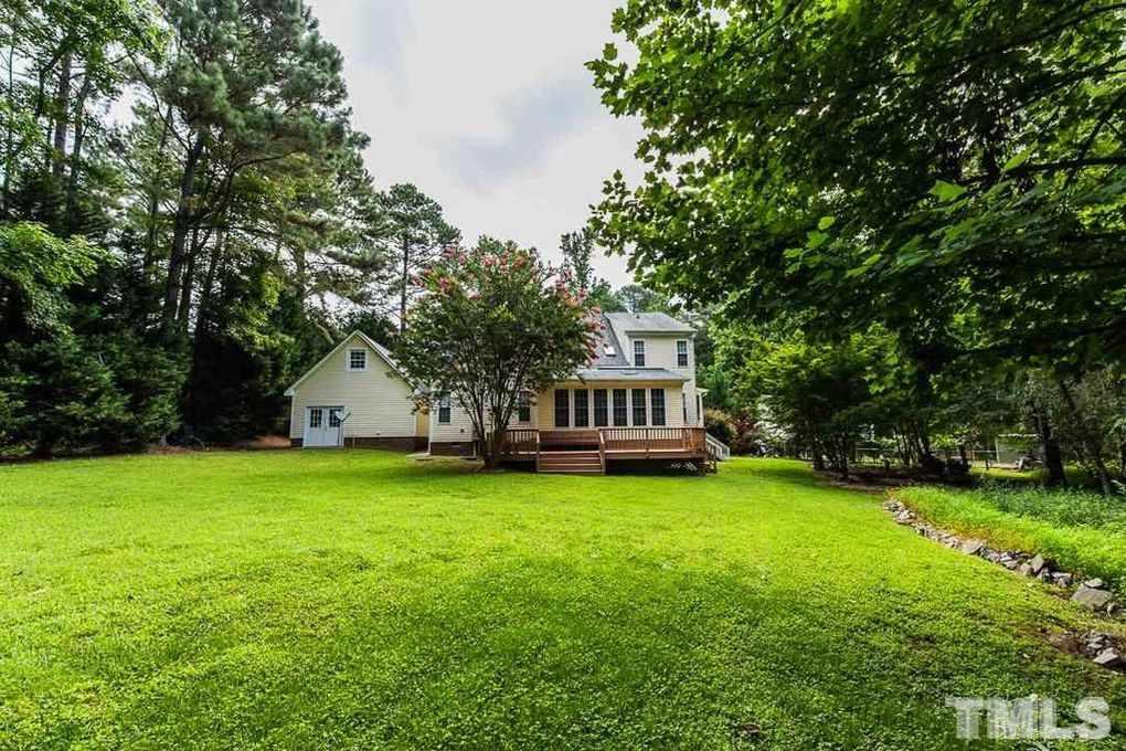 1244 Torchlight Way Raleigh, NC 27603 - Photo 5 of 20 a house that is sitting in the grass with tress in the background