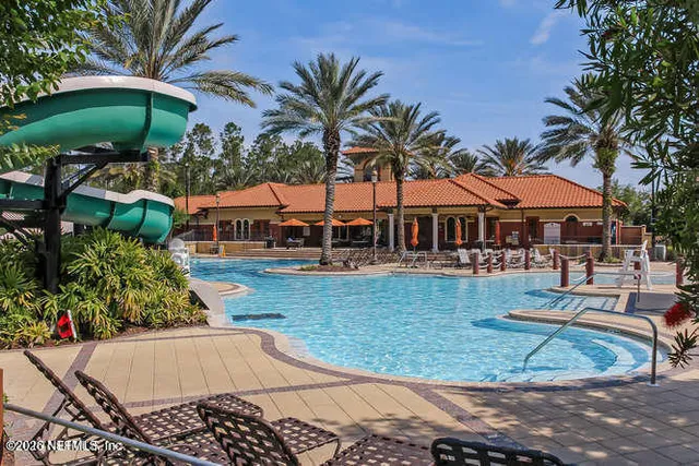 a view of a backyard with plants and a patio