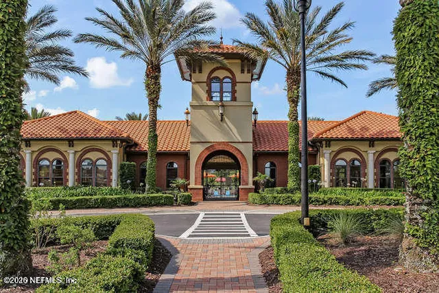 a backyard of a house with barbeque oven table and chairs