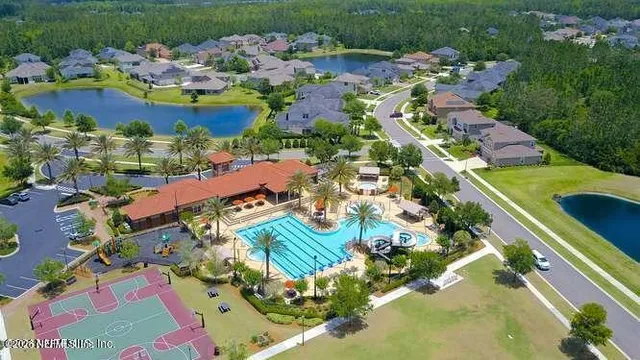an aerial view of a residential houses with outdoor space