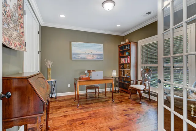 a living room with furniture and a bookshelf