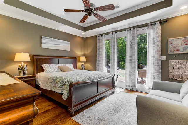 a bedroom with a large bed and a chandelier