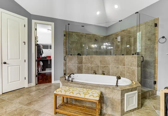 a bathroom with a tub and a shower