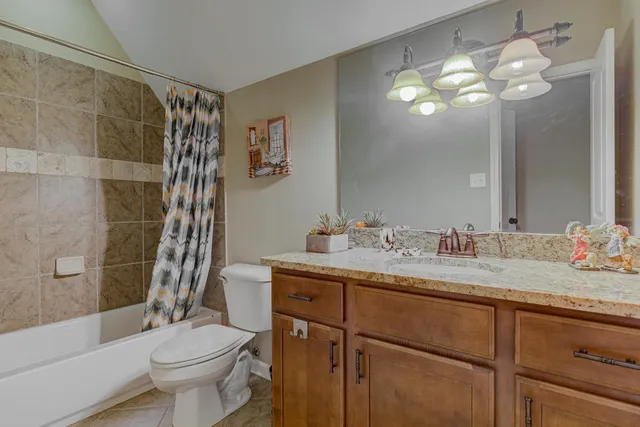 a bathroom with a sink vanity mirror and toilet