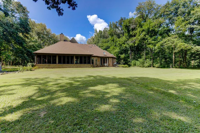 a white house with a big yard
