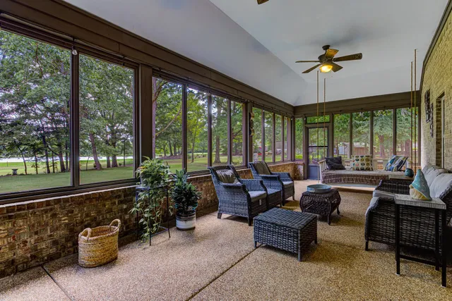 a living room with furniture and a floor to ceiling window