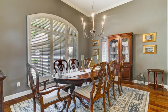 a view of a dining room with furniture and chandelier