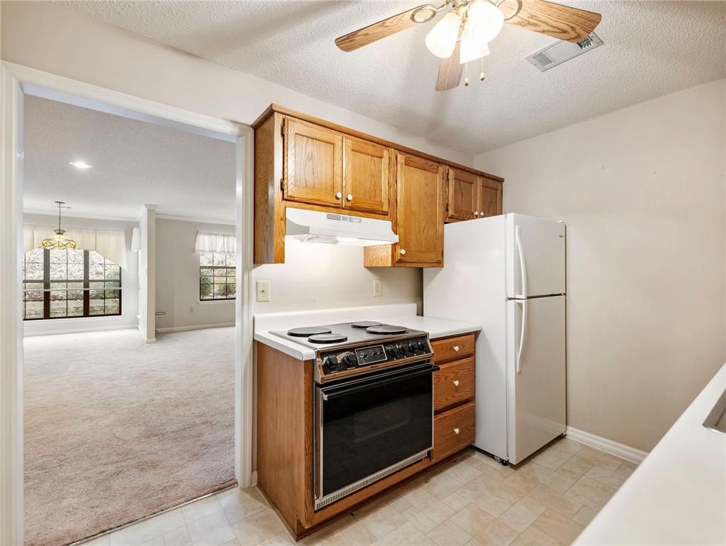 2235 Old Hamilton Place, Unit 100B Gainesville, GA 30507 - Photo 11 of 31 a kitchen with stainless steel appliances granite countertop a stove a refrigerator and a refrigerator