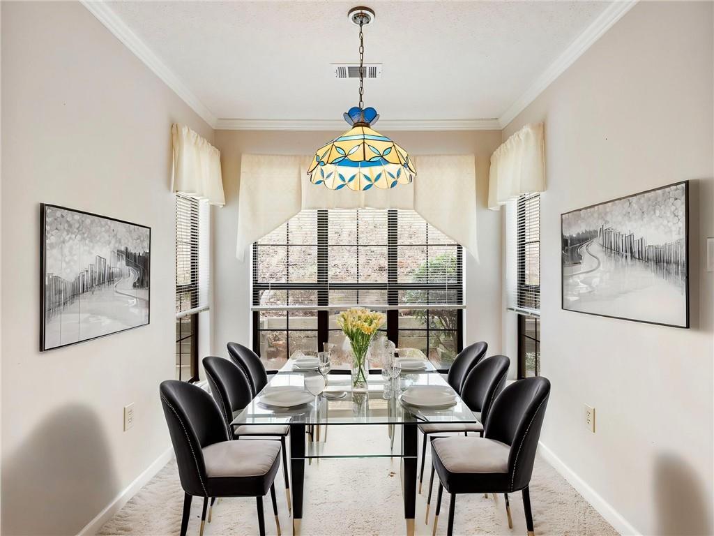 2235 Old Hamilton Place, Unit 100B Gainesville, GA 30507 - Photo 13 of 31 a dining room with furniture a large window and a chandelier
