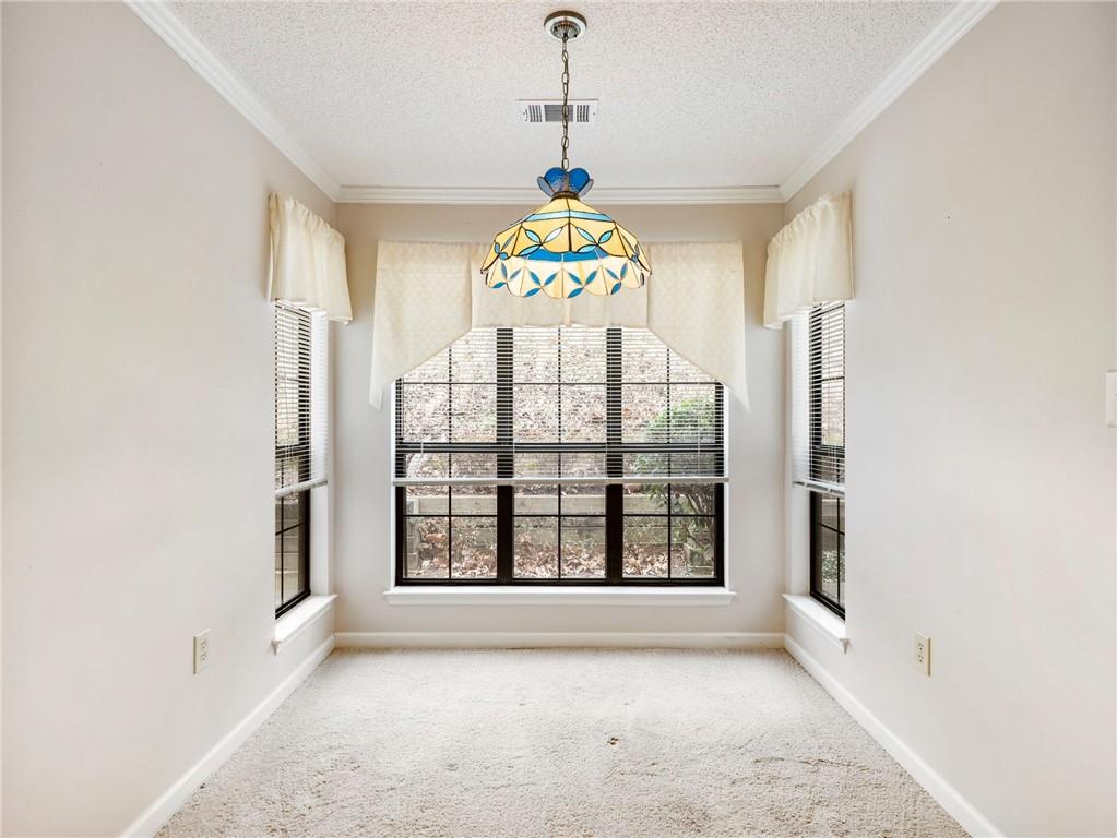 2235 Old Hamilton Place, Unit 100B Gainesville, GA 30507 - Photo 14 of 31 an empty room with windows and chandelier