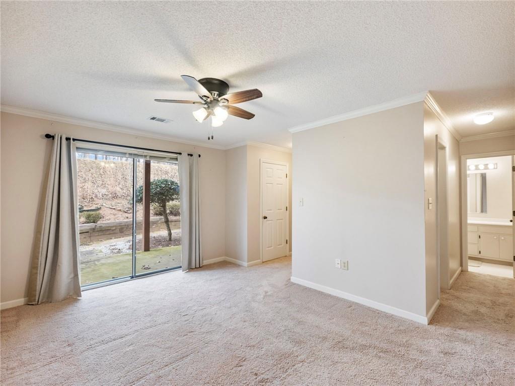 2235 Old Hamilton Place, Unit 100B Gainesville, GA 30507 - Photo 16 of 31 an empty room with chandelier fan and windows
