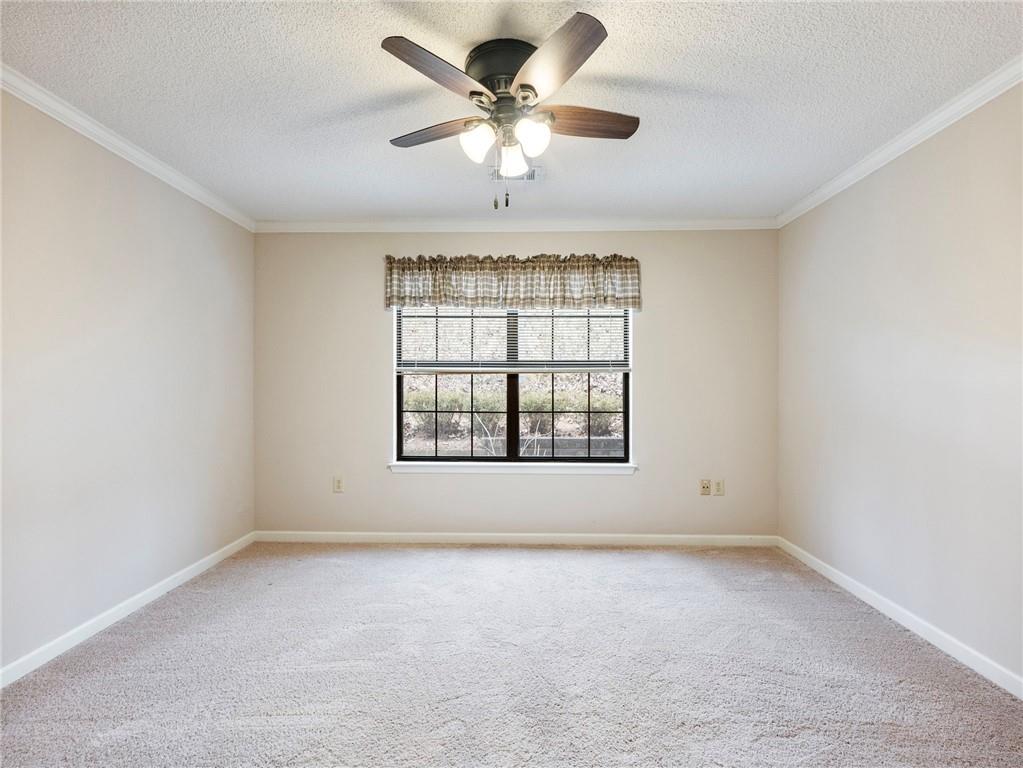 2235 Old Hamilton Place, Unit 100B Gainesville, GA 30507 - Photo 22 of 31 an empty room with a ceiling fan and window