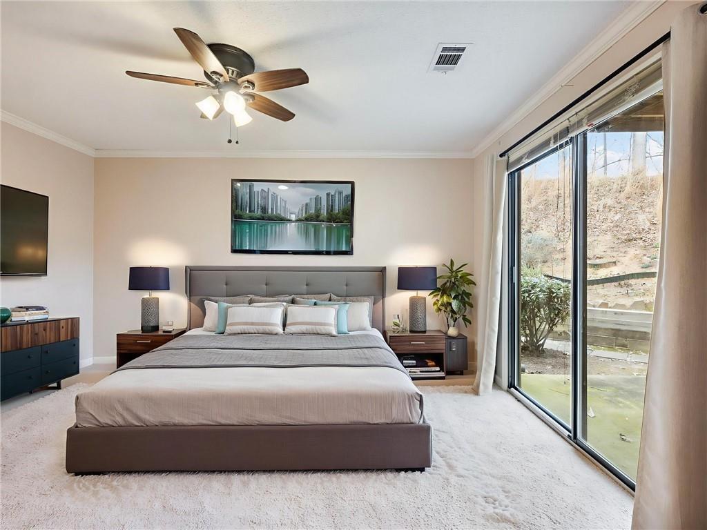 2235 Old Hamilton Place, Unit 100B Gainesville, GA 30507 - Photo 26 of 31 a bedroom with a balcony a bed and a flat screen tv