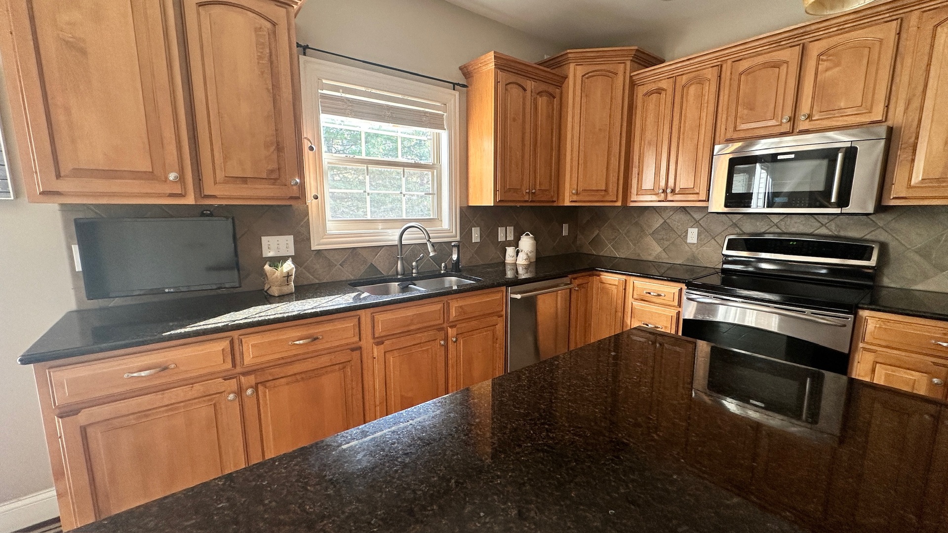 2906 Springhill Lane Champaign, IL 61822 - Photo 11 of 48 a kitchen with stainless steel appliances granite countertop white cabinets granite counter tops and a window