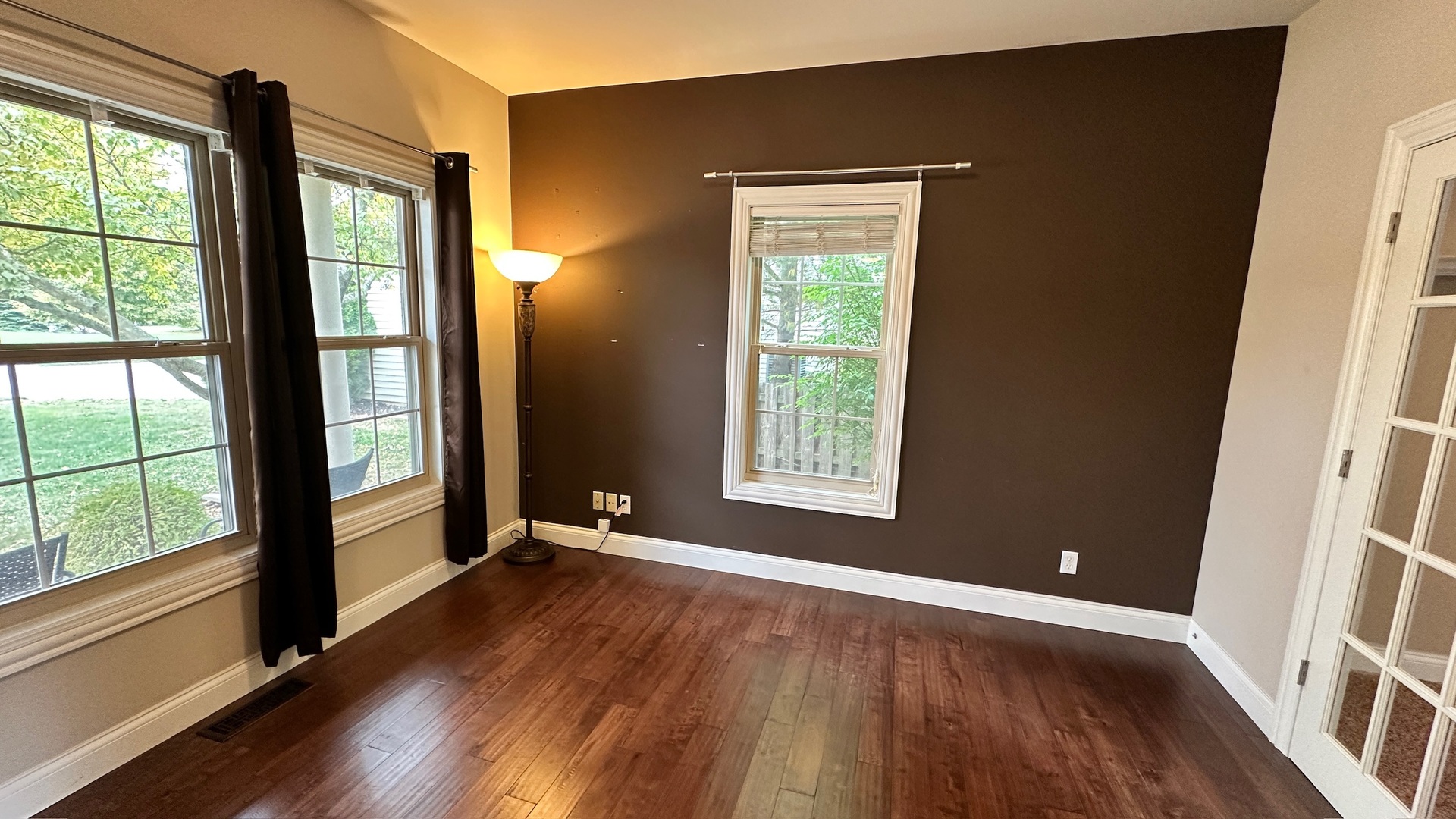 2906 Springhill Lane Champaign, IL 61822 - Photo 14 of 48 a view of an empty room with wooden floor and a window