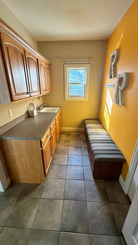 a bathroom with a tub sink and mirror