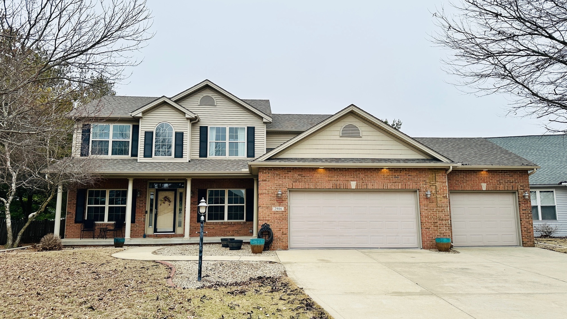 2906 Springhill Lane Champaign, IL 61822 - Photo 2 of 48 a front view of a house with a yard and garage