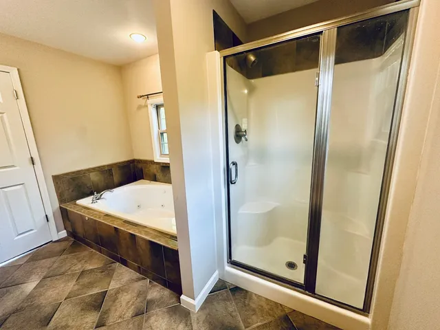 a bathroom with a tub and a glass door
