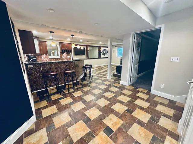 a room with wooden floor and furniture