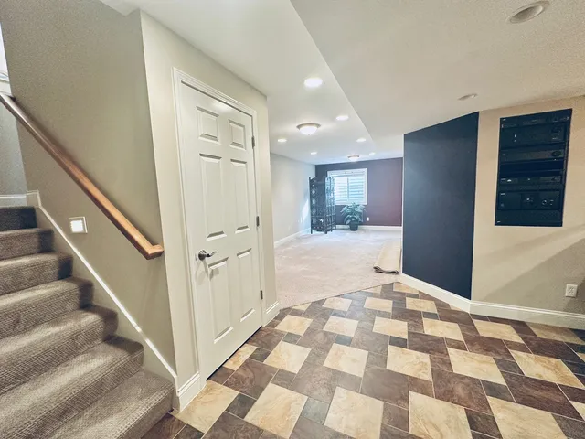 a view of a hallway with wooden floor and windows
