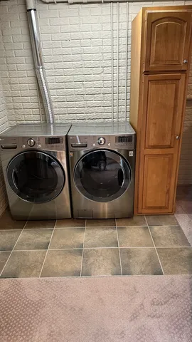 a view of a storage and utility room with washer and dryer