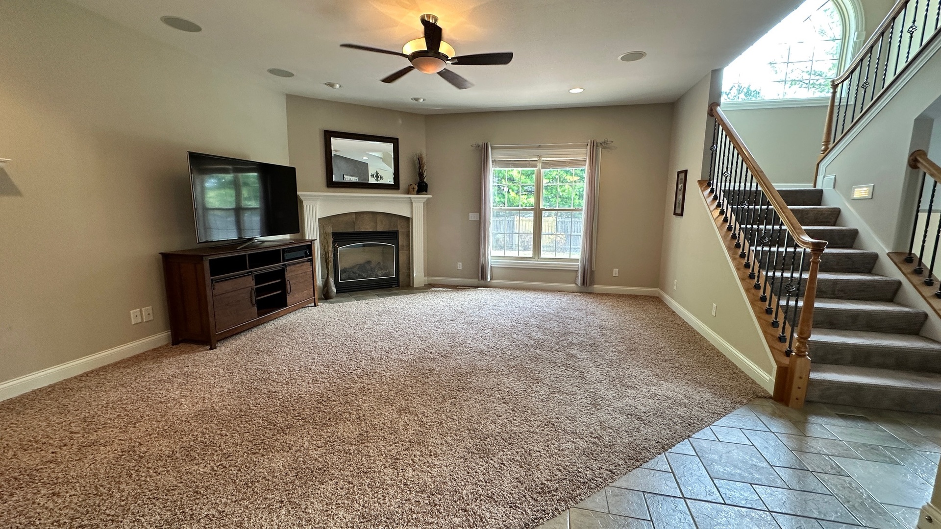 2906 Springhill Lane Champaign, IL 61822 - Photo 5 of 48 a view of a livingroom with a fireplace a ceiling fan and windows