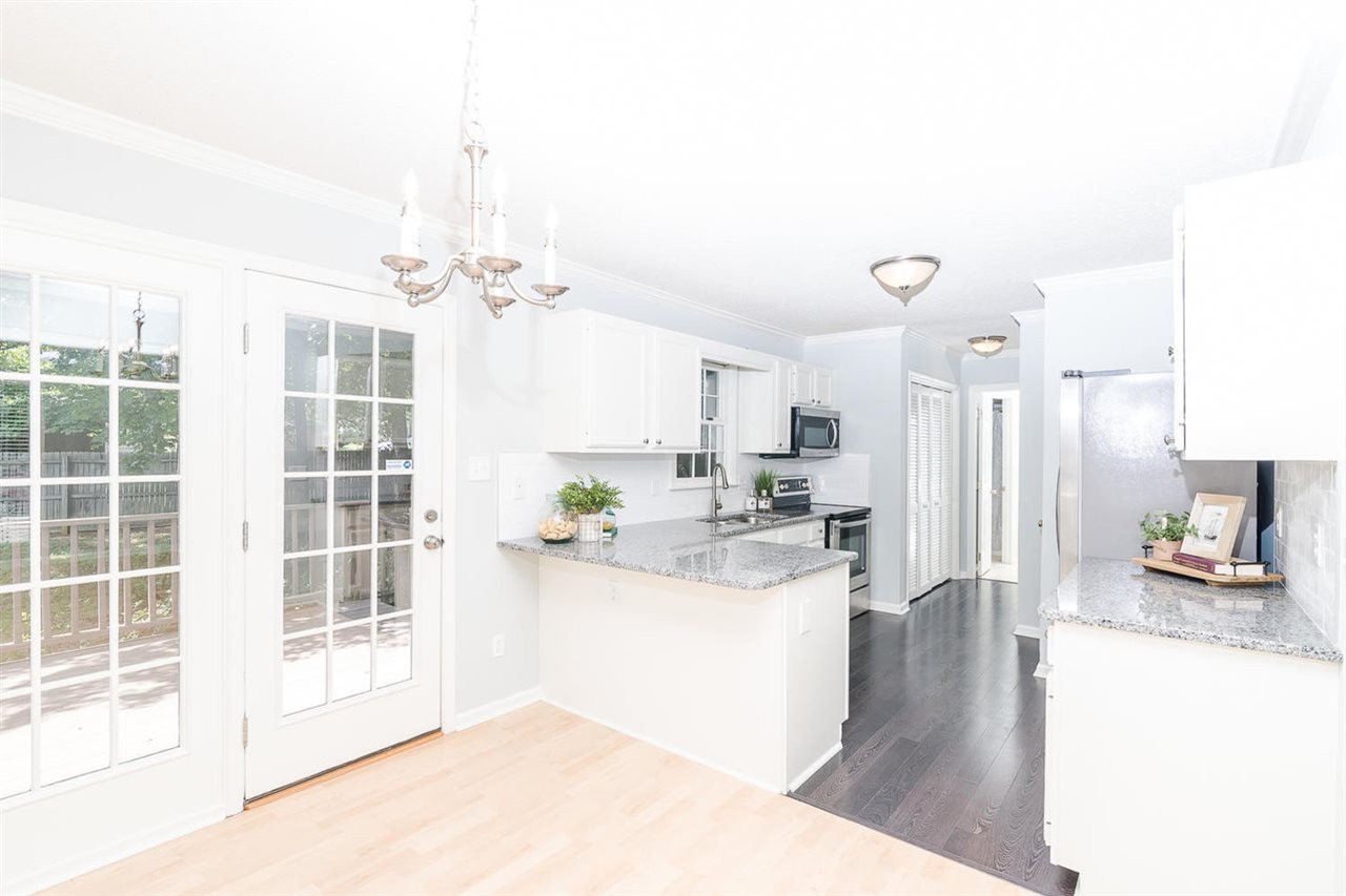 308 Crosspine Drive Raleigh, NC 27603 - Photo 4 of 11 Beautifully updated kitchen- new granite countertops, subway backsplash, and stainless steel appliances. Kitchen