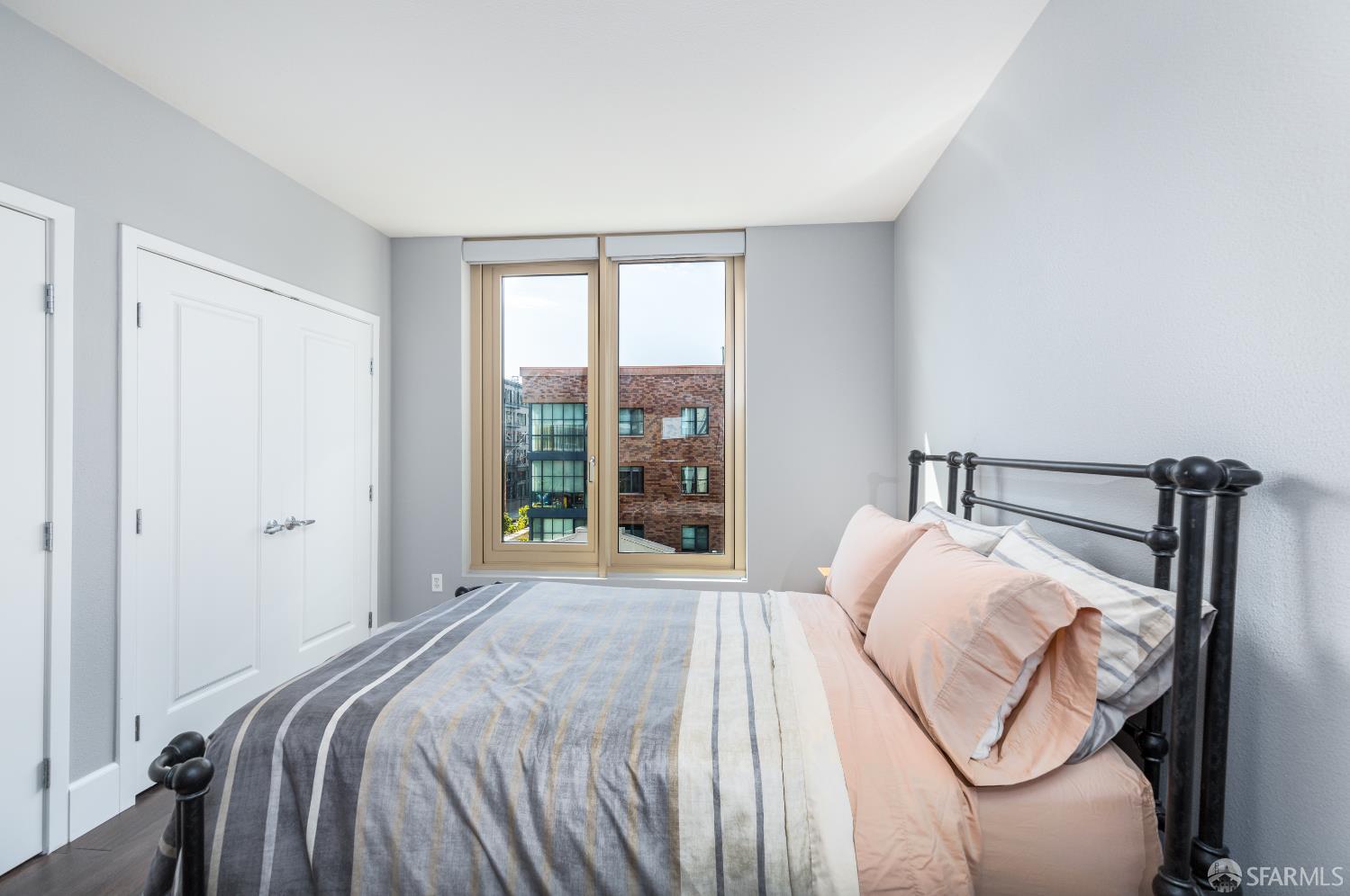 88 King Street, Unit 513 San Francisco, CA 94107 - Photo 15 of 41 a bedroom with a bed and a large window