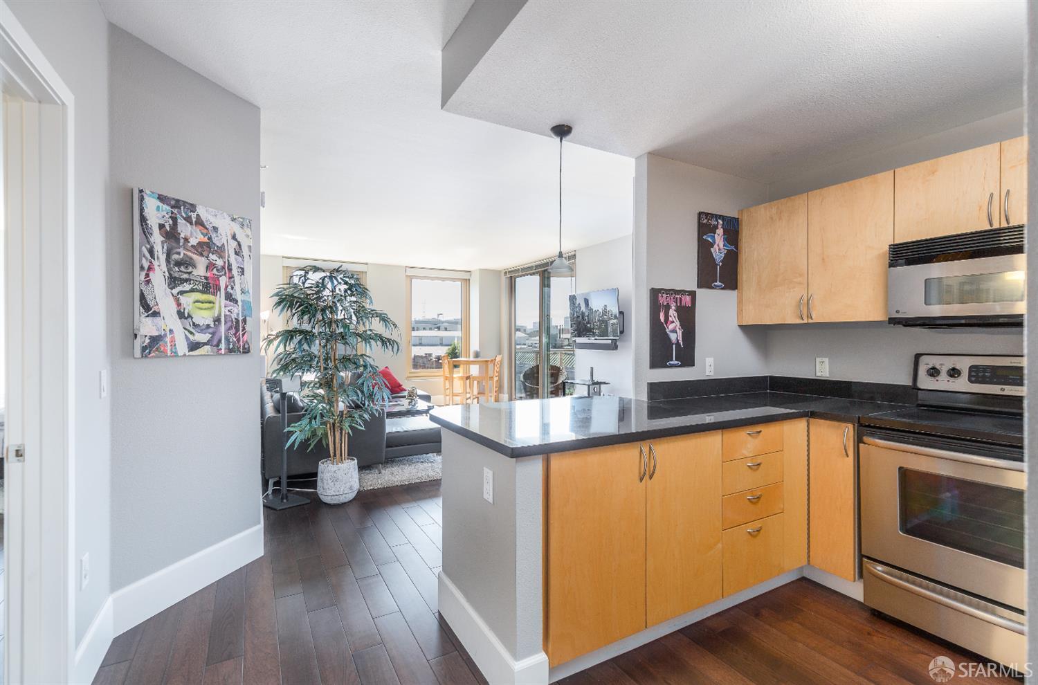 88 King Street, Unit 513 San Francisco, CA 94107 - Photo 2 of 41 a kitchen with stainless steel appliances white cabinets and a wooden floor